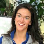 Picture of MIEA Certified Mindfulness teacher Maria Sperduto smiling wearing a blue shirt and gray vest.
