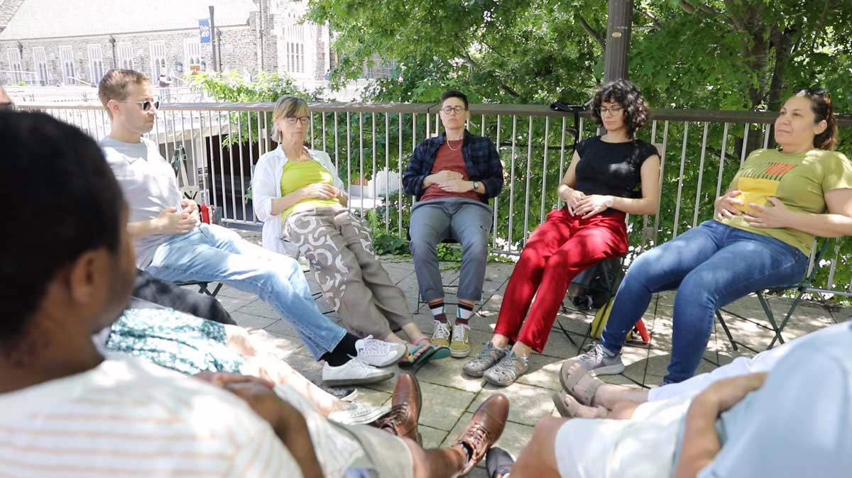 Teacher and group of students meditating together