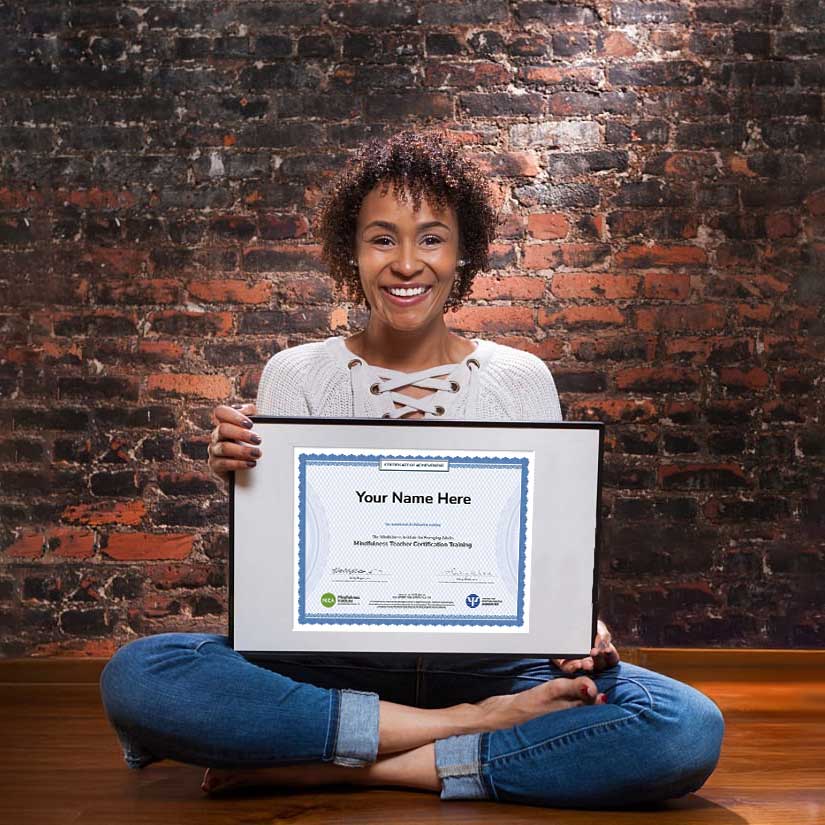 A MIEA Mindfulness teacher holding a sample teacher certificate